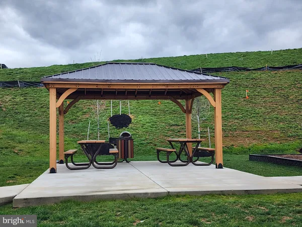 a view of a wooden deck with chairs and a yard