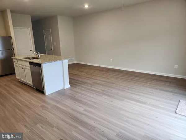 a kitchen with stainless steel appliances a refrigerator sink and microwave