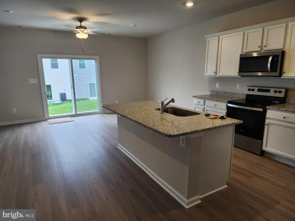 a kitchen with a stove a sink and a refrigerator