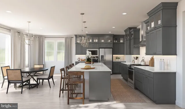 a large kitchen with kitchen island a sink table and chairs