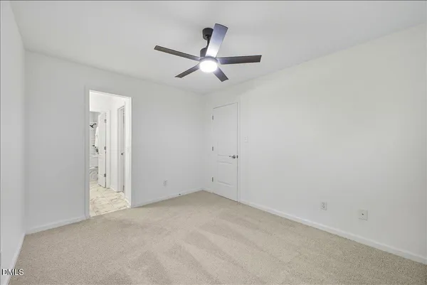 an empty room with closet and windows