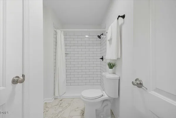 a bathroom with a toilet and shower
