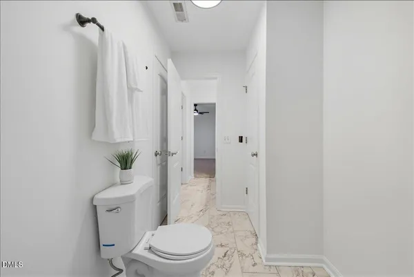 a white toilet sitting next to a bathroom sink