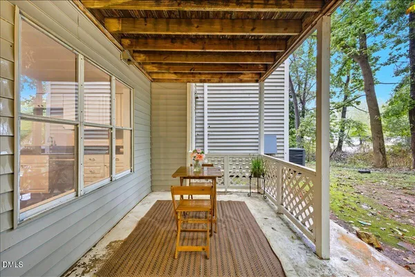 a balcony with wooden floor and furniture