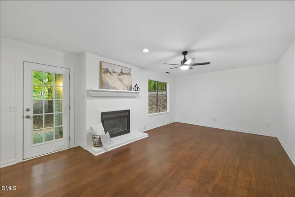 a view of a livingroom with a fireplace and window