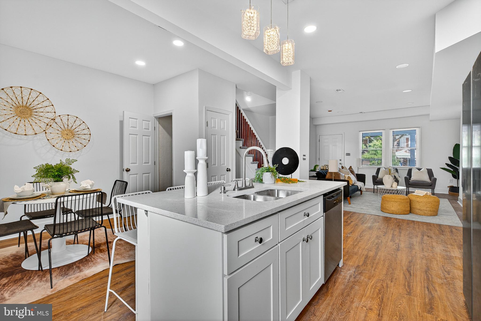 a kitchen with a sink stove and wooden floor