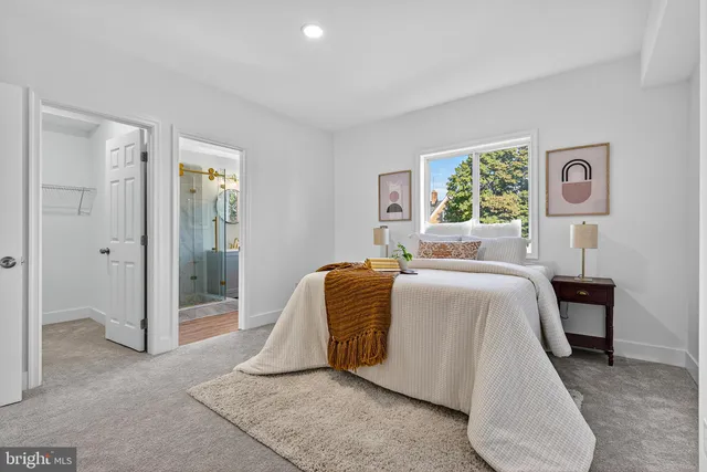 a bedroom with a bed and painting on the wall