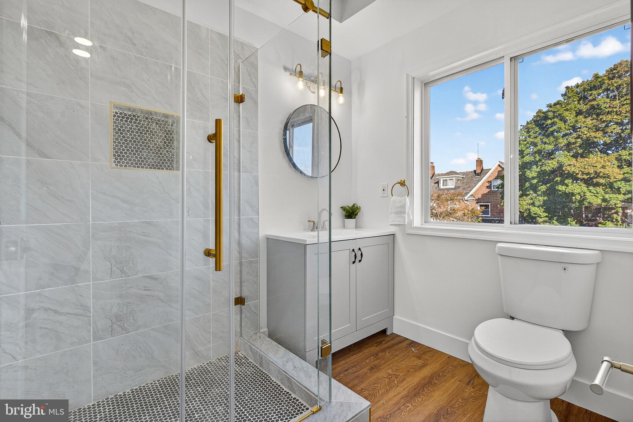 802 North Woodington Road Baltimore, MD 21229 - Photo 16 of 41 a bathroom with a toilet a sink and mirror