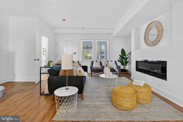 a living room with fireplace furniture and a wooden floor