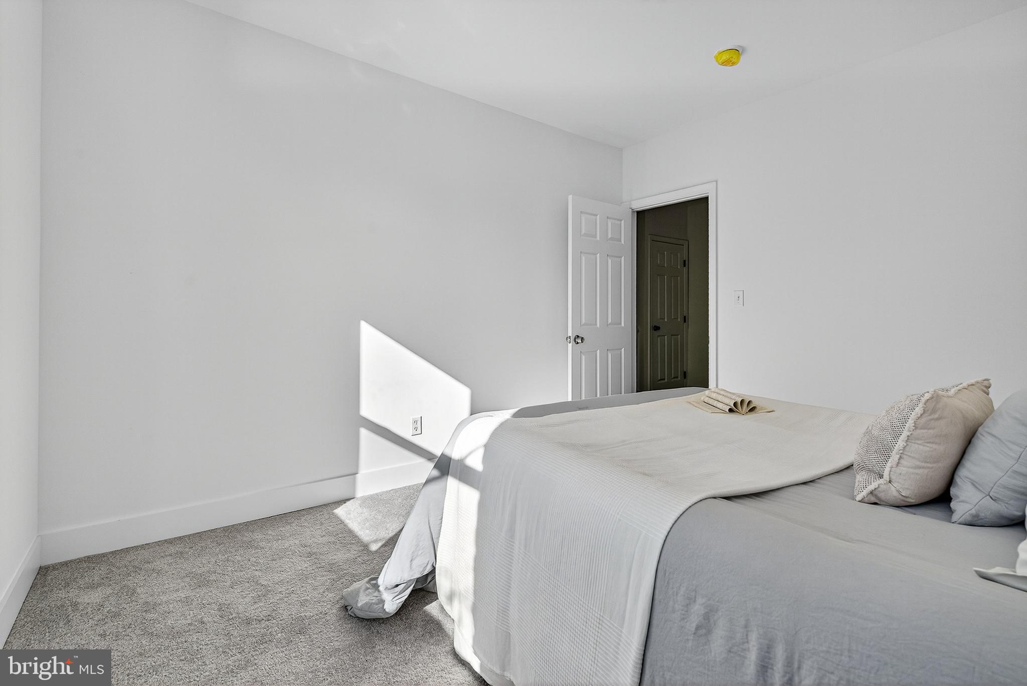 802 North Woodington Road Baltimore, MD 21229 - Photo 24 of 41 a bedroom with a bed and a table in it