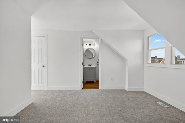 a view of empty room with cabinet and painted walls