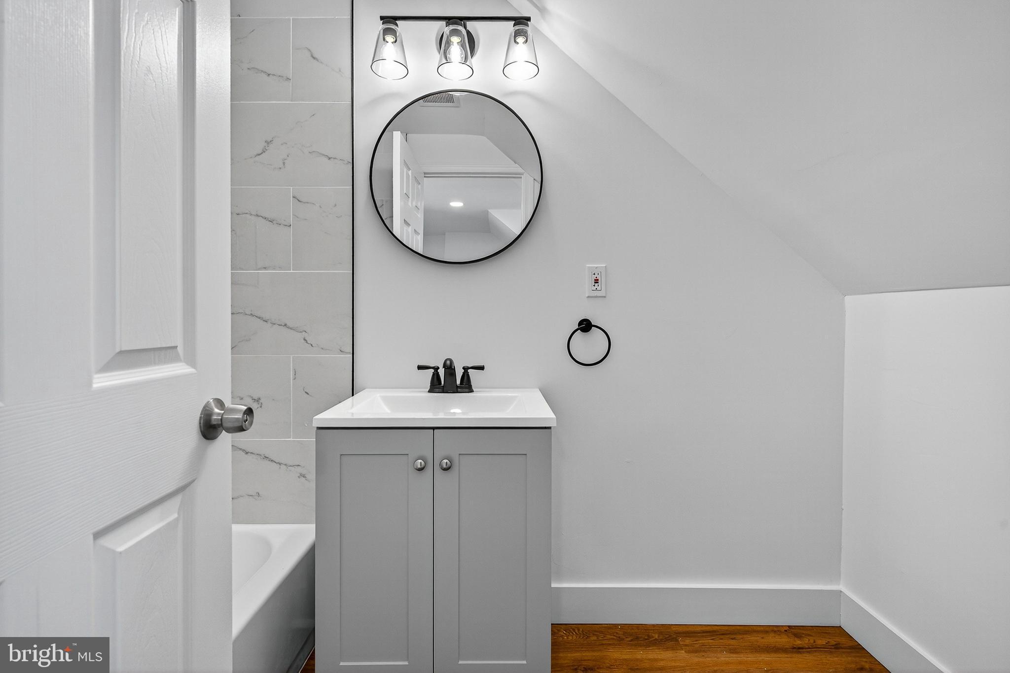 802 North Woodington Road Baltimore, MD 21229 - Photo 28 of 41 a bathroom with a sink and a mirror