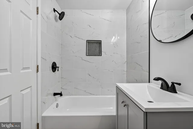 a bathroom with a sink a bathtub and a shower