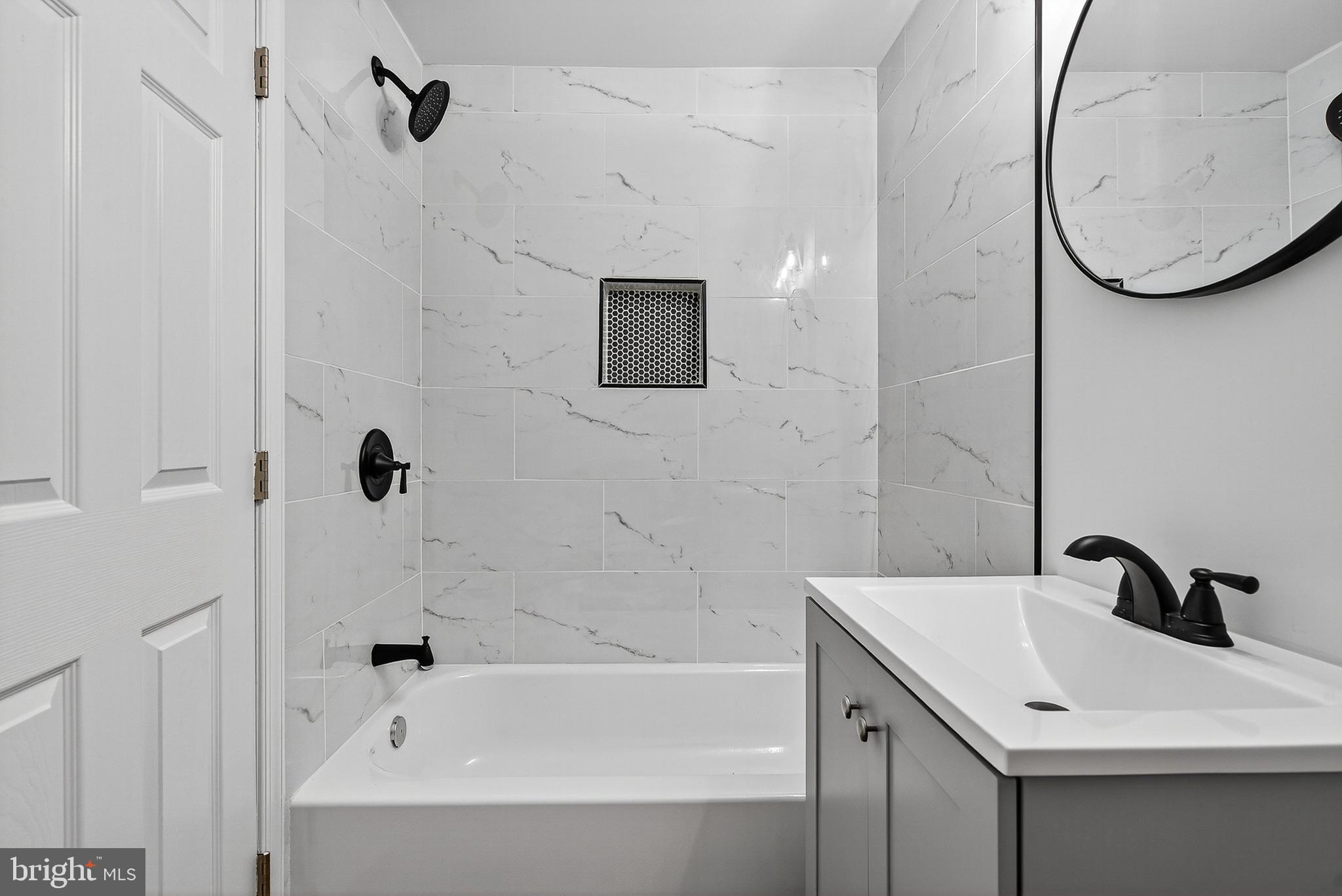 802 North Woodington Road Baltimore, MD 21229 - Photo 29 of 41 a bathroom with a sink a bathtub and a shower