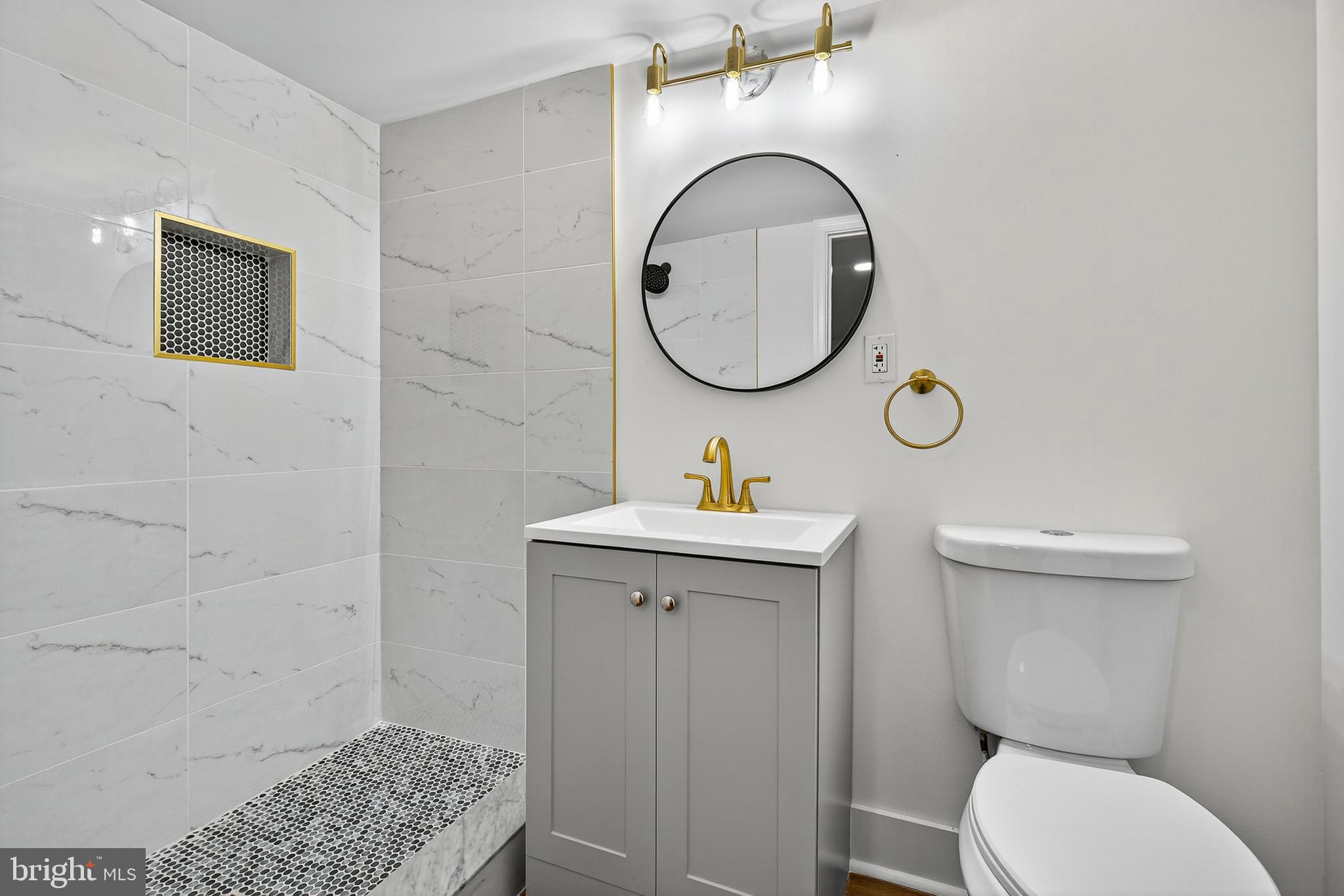 802 North Woodington Road Baltimore, MD 21229 - Photo 33 of 41 a bathroom with a toilet a sink and a mirror