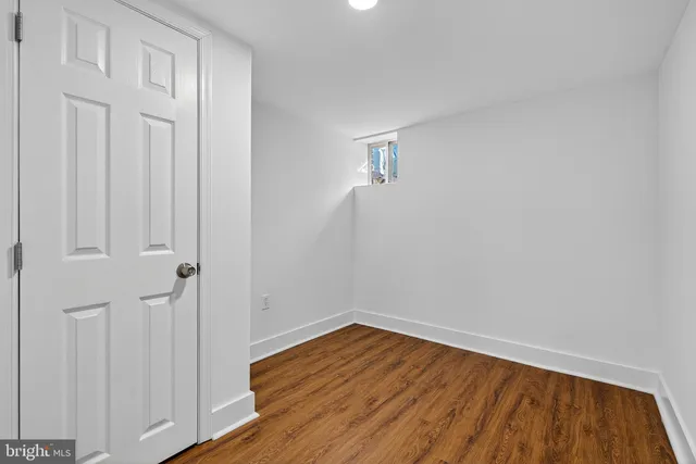 a view of a room with wooden floor