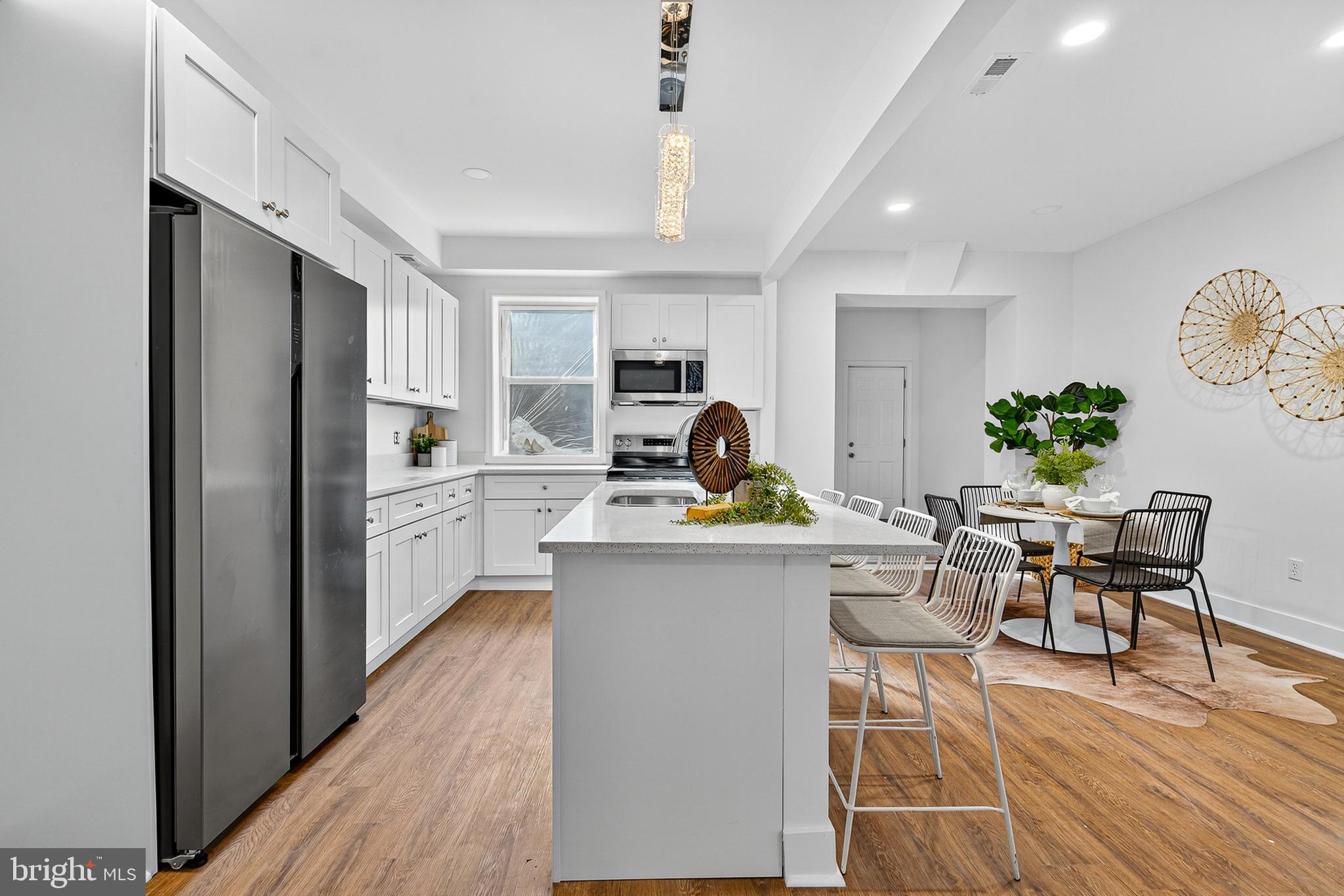 802 North Woodington Road Baltimore, MD 21229 - Photo 7 of 41 a kitchen with a sink appliances and dining table