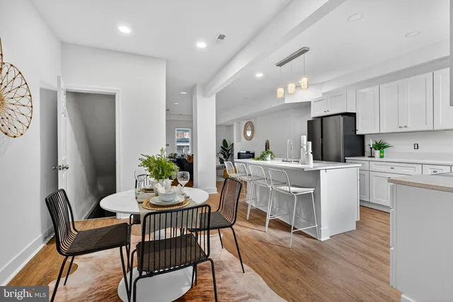 a dining room with furniture and wooden floor
