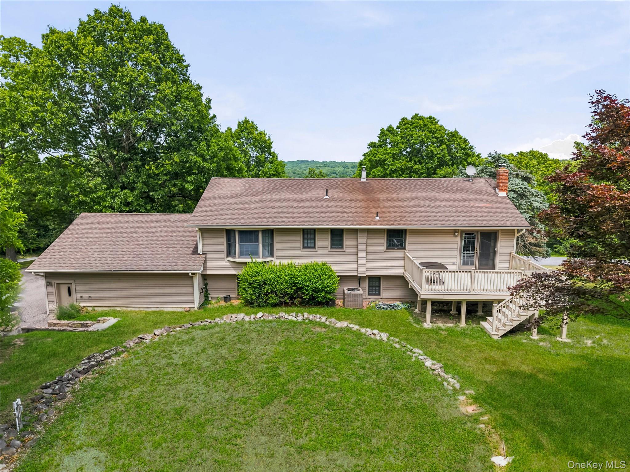 318 Beattie Road Washingtonville, NY 10992 - Photo 38 of 42 a front view of a house with a garden and plants
