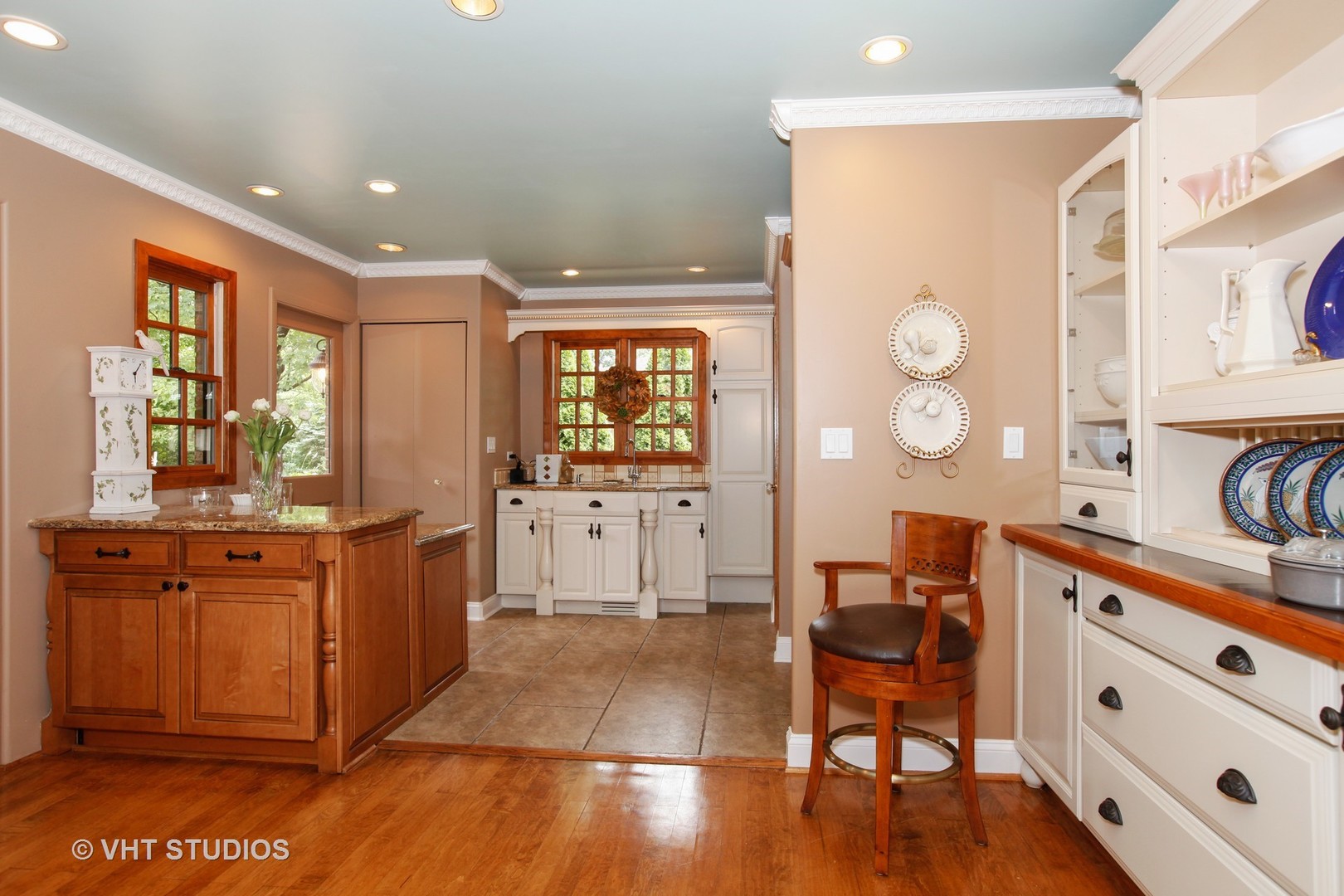 39 Mockingbird Lane Oak Brook, IL 60523 - Photo 13 of 45 a large kitchen with stainless steel appliances a stove a sink dishwasher and a dining table with wooden floor