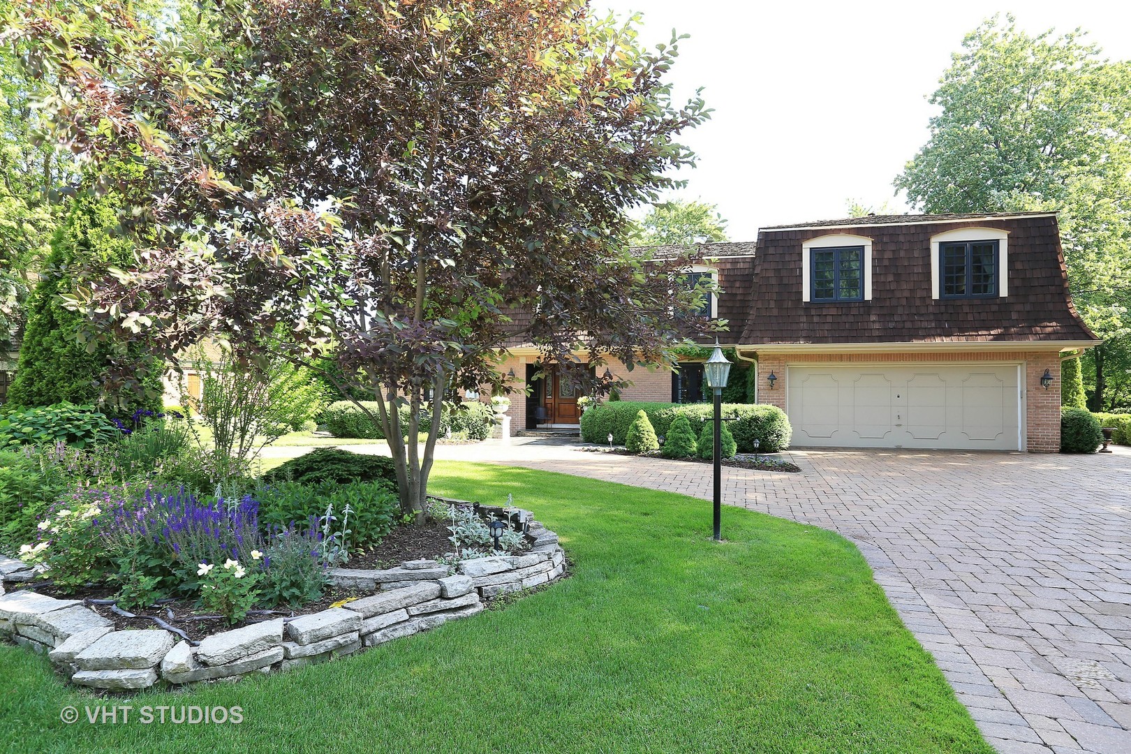 39 Mockingbird Lane Oak Brook, IL 60523 - Photo 32 of 45 a view of a house with a yard and a garden