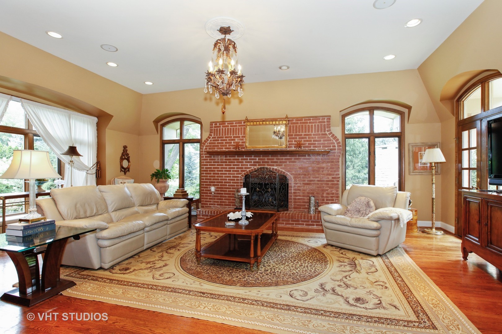 39 Mockingbird Lane Oak Brook, IL 60523 - Photo 4 of 45 a living room with furniture a fireplace and a chandelier
