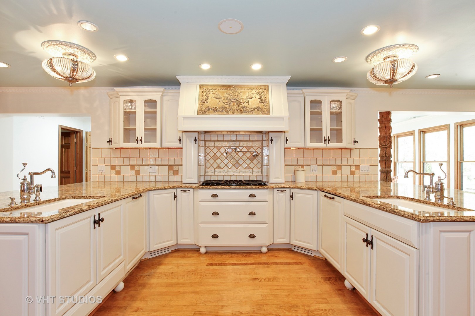 39 Mockingbird Lane Oak Brook, IL 60523 - Photo 10 of 45 a large kitchen with granite countertop a large window and white cabinets