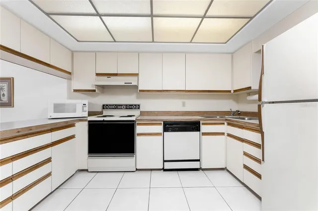 a kitchen with a stove top oven and cabinets