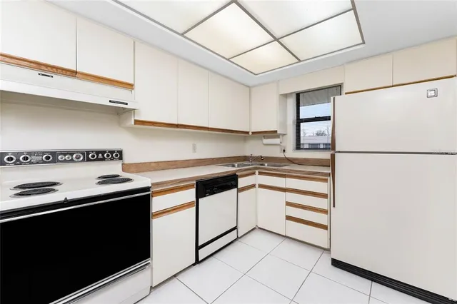 a kitchen with stainless steel appliances a sink and a refrigerator