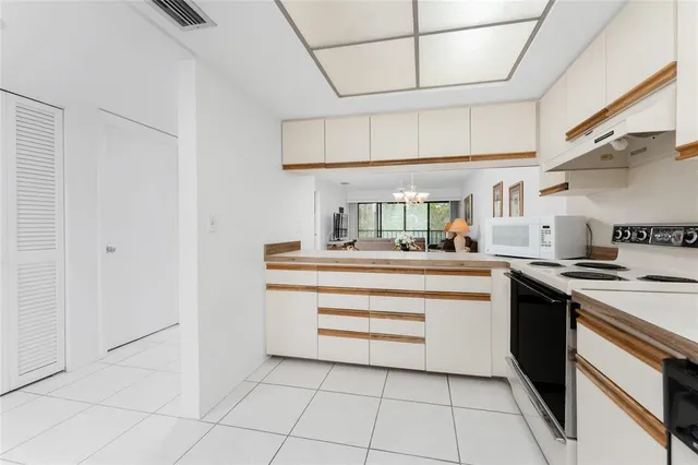 a kitchen with cabinets and appliances