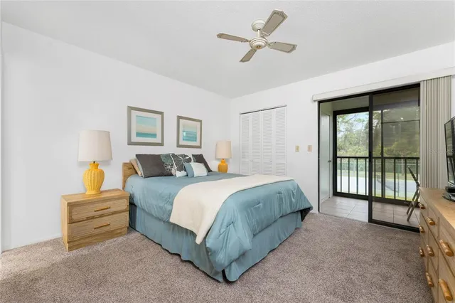 a spacious bedroom with a bed a couch and a large window