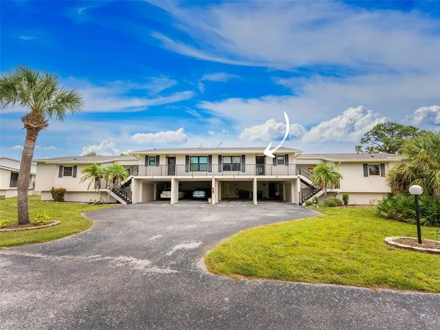 a view of a house with swimming pool and sitting area