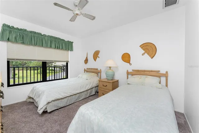 a bedroom with two beds and window