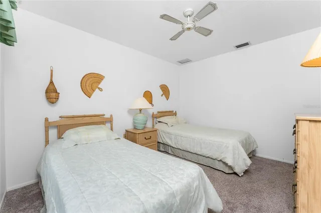a bedroom with two beds and a chandelier