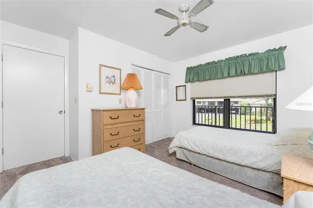 a bedroom with a bed a dresser and a window