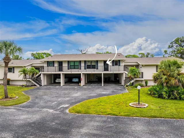 an aerial view of a house with a garden and lake view