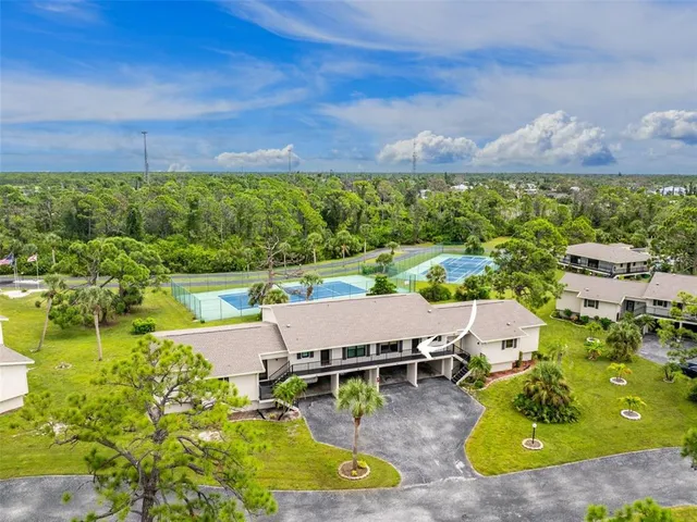 an aerial view of residential houses with outdoor space and street view