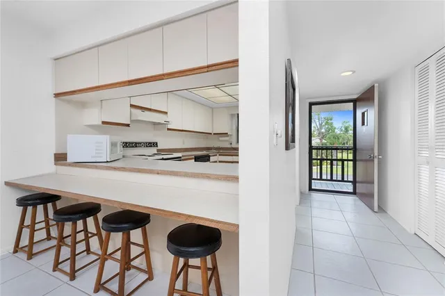 a kitchen with stainless steel appliances granite countertop a sink and a refrigerator