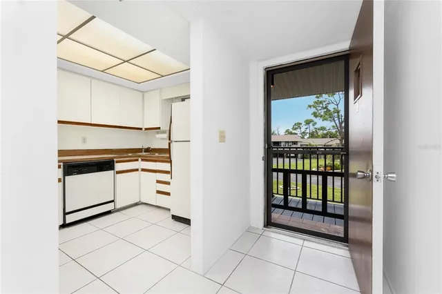 a kitchen with white cabinets and white appliances