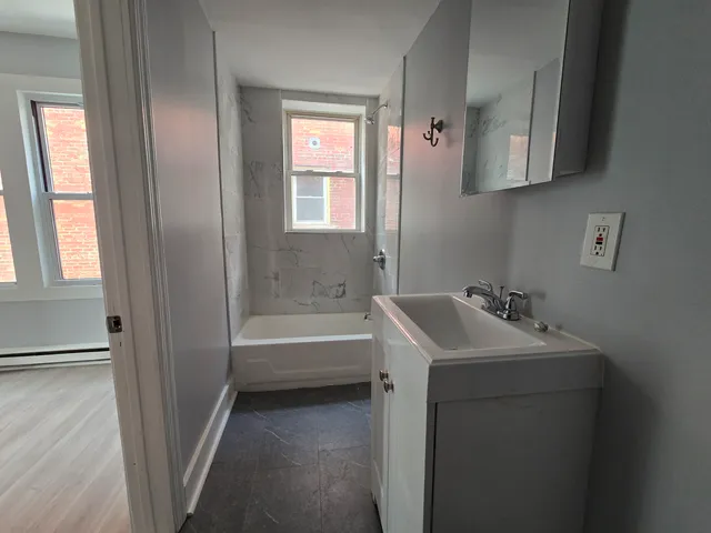 a bathroom with a sink toilet and tub