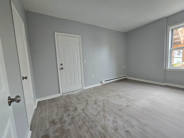 a view of an empty room and a window