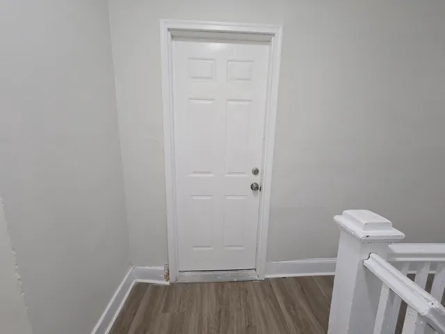 a view of a room with wooden floor