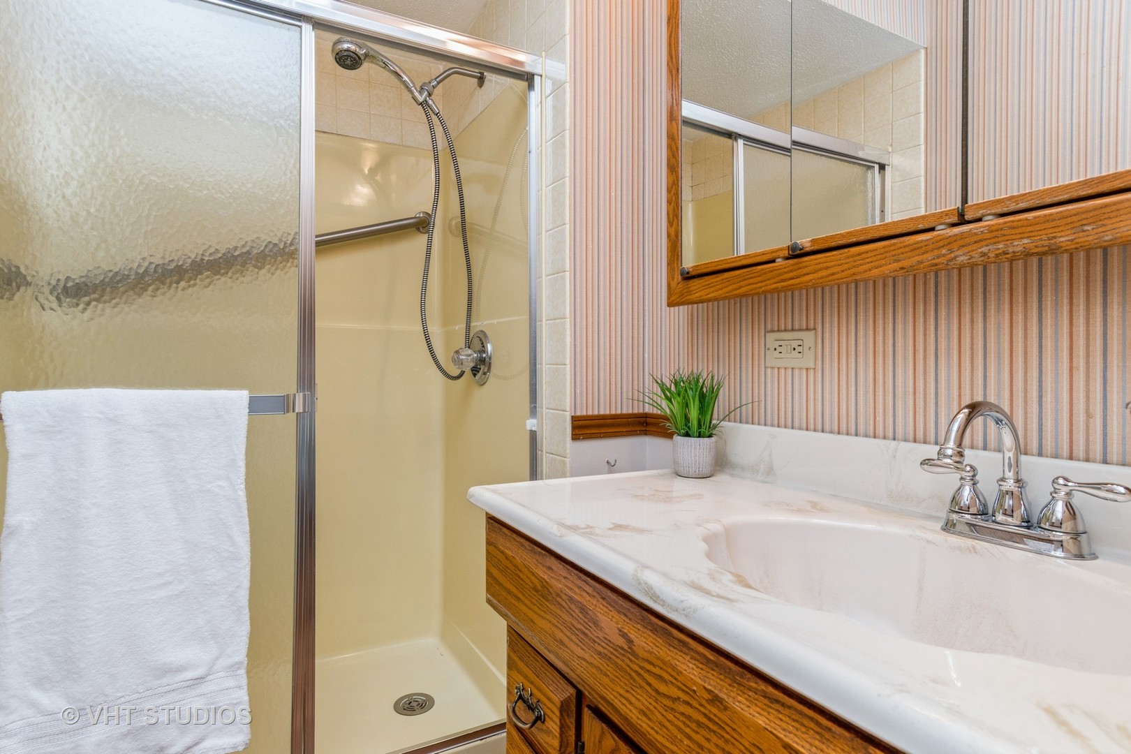 809 Oakton Avenue Romeoville, IL 60446 - Photo 13 of 23 a bathroom with a granite countertop sink and a shower