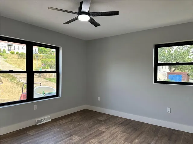 wooden floor in an empty room with a window