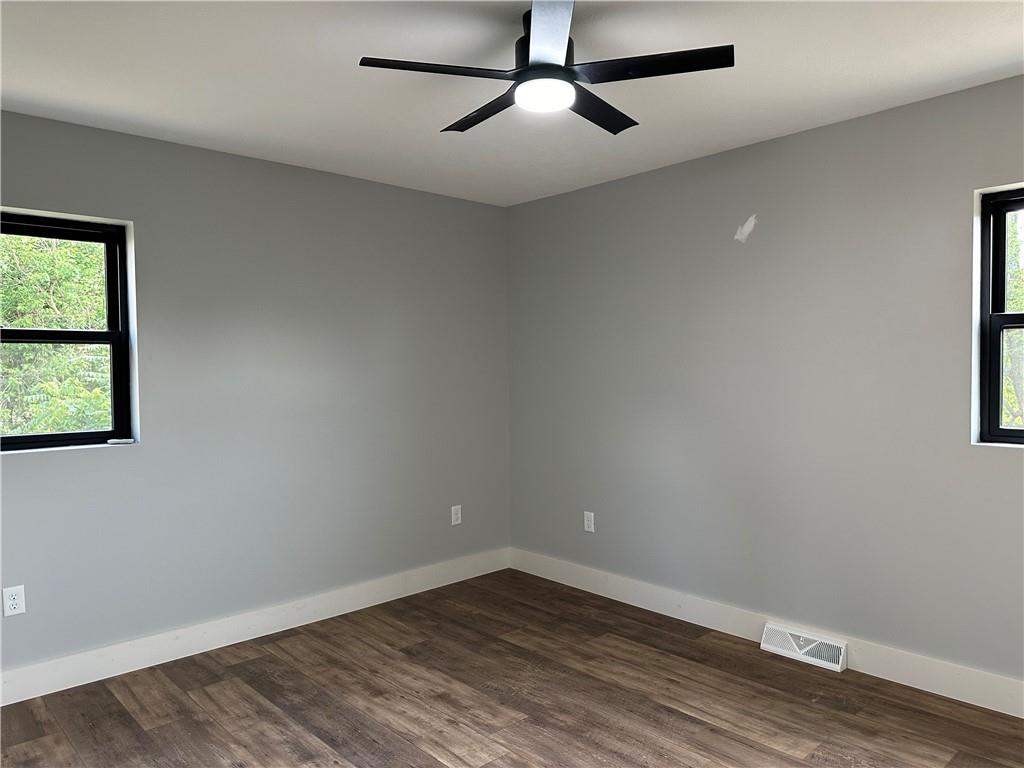 121 Hillview Road Jefferson Hills, PA 15025 - Photo 15 of 42 an empty room with wooden floor fan and windows