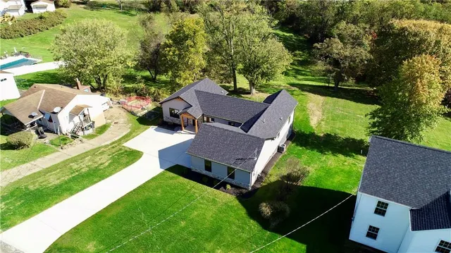 an aerial view of house with yard