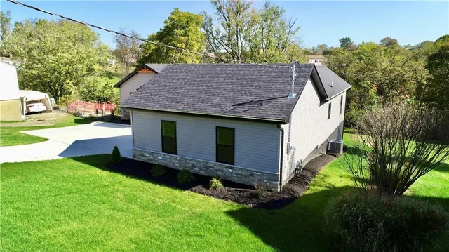 a front view of house with yard and green space
