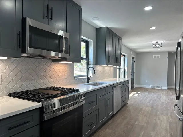 a kitchen with a stove and a microwave