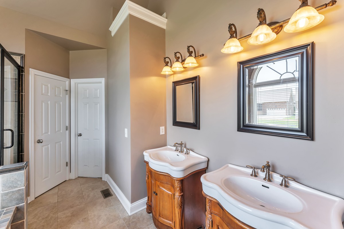 457 Bowling Branch Road Cottontown, TN 37048 - Photo 17 of 38 a bathroom with 2 sink and a mirror