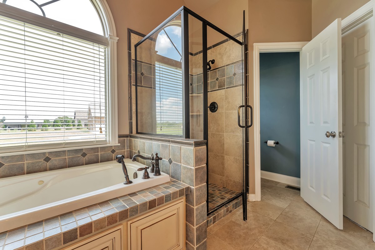 457 Bowling Branch Road Cottontown, TN 37048 - Photo 18 of 38 a bathroom with a granite countertop sink and a large mirror